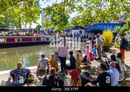 People cheering on approaching canal boats at IWA Canalway Cavalcade 2025, London, England Stock Photo