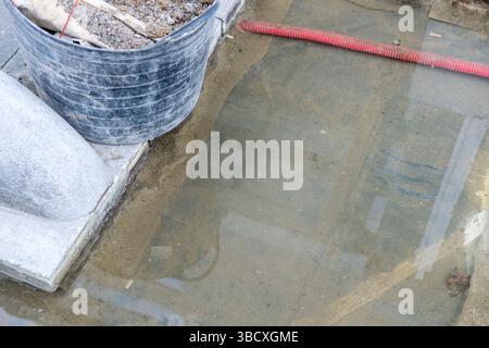 preparing ground for garden paver pathway construction paver installation in progress with flexible work tubs Stock Photo