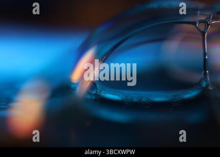 Blue reflections of liquid in macro, bright liquid surface, bubbles in macro, connection of bubbles in macro, cell from liquid, scientific background Stock Photo