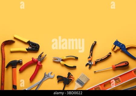 Different construction tools on orange background Stock Photo