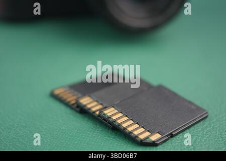 Multiple memory cards displayed on a green surface Stock Photo