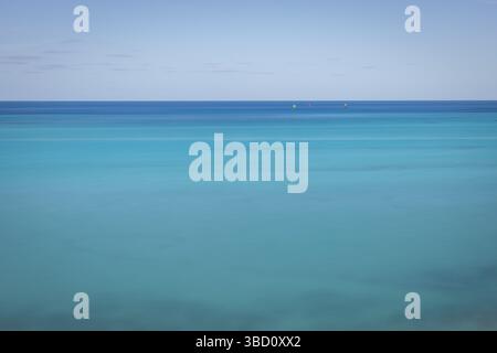 Long-exposure view of the turquoise Atlantic Ocean near Bermuda, with calm water and minimal detail for a serene and abstract composition. Stock Photo