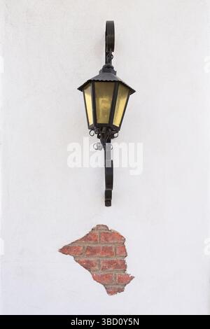 Black lamp mounted on a white wall Stock Photo
