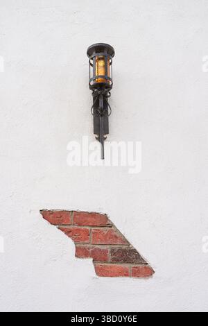 Black lamp mounted on a white wall Stock Photo