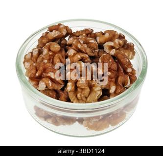 Walnut halves in a transparent glass bowl macro isolated щт цршеу Stock Photo