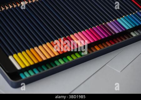 Set of two rows of colored pencils in a pencil case. Big beautiful color palette watercolor pencils for creativity drawing, close-up, high resolution. Stock Photo