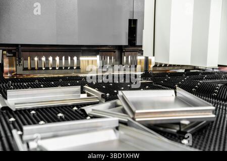 Automatic metal sheet bending machine at work in factory. CNC Panel Bender (Press Arm Type) Stock Photo