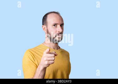 young man pointing finger at camera with serious confident expression Stock Photo