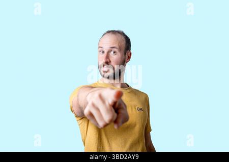 young man pointing finger at camera with serious confident expression Stock Photo