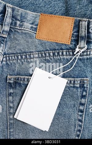 Blue jeans with blank tag. Empty label for branding. New denim pants detail. Back pocket view. Fashion clothing concept. Retail shopping idea. Stock Photo