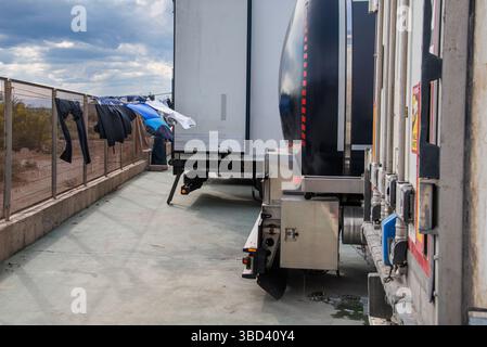 Laundry hanging on a drying rack attached to the rear of a truck, illustrating life on the road for international drivers during long hauls.driver Stock Photo