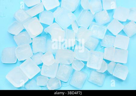 Many frozen ice cubes on blue background Stock Photo