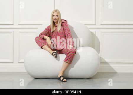 Blonde woman in a cozy soft and warm home suit Stock Photo