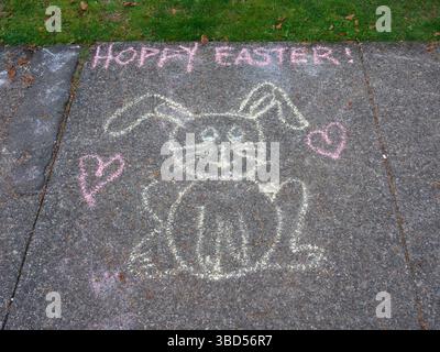Child's chalk drawing of Happy Easter (Hoppy Easter) bunny on the sidewalk Stock Photo