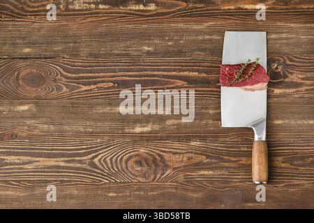Piece of raw beef brisket flat steak on butcher's cleaver with place for text Stock Photo