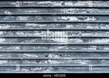 corrugated metal wall with peeling paint textured background Stock Photo