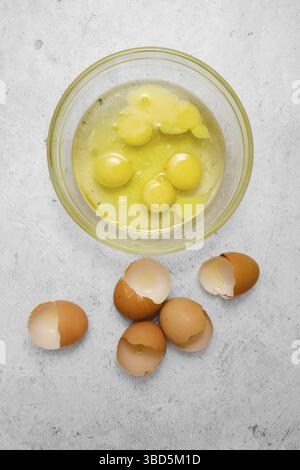 Top view of broken chicken eggs in a glass bowl Stock Photo