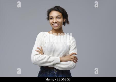 Portrait of beautiful happy black woman standing with arms crossed Stock Photo