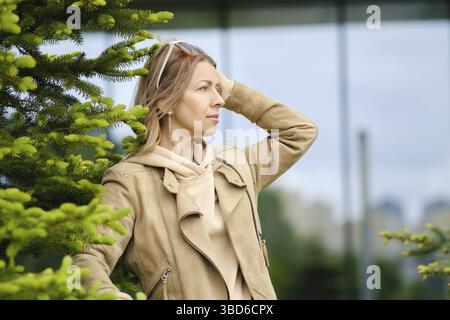 Pretty middle-aged woman looks into the distance Stock Photo