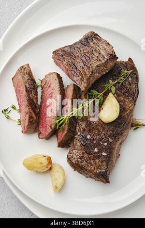 Overhead view of beef strip steak medium rare on a plate Stock Photo