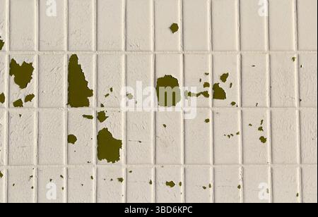 Peeling paint on damaged white tiles abstract textured background Stock Photo