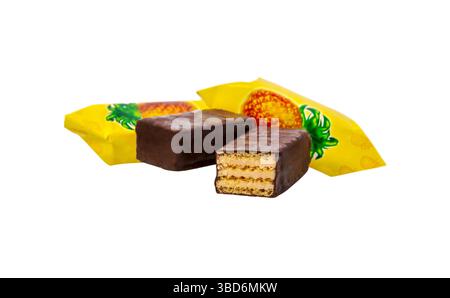 Chocolate candy stuffed with crispy wafers and caramel isolated on a white background. Chocolate wafer bars with pineapple flavor Stock Photo