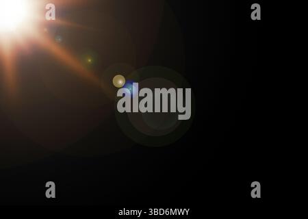 Sunrays or sunlight effect, lens flare, light leaks, overlays, or flare light on a black background. Glow, bright, and shine Stock Photo