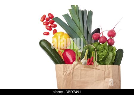 Paper bag with fresh vegetables isolated on white background Stock Photo