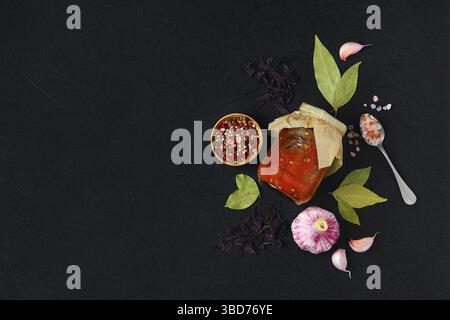 Overhead view of fried eggplant with bell pepper, garlic and spices preserved in tincan Stock Photo