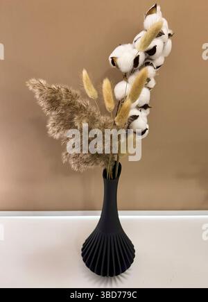 3D printed black vase home decor with reed flowers flowing geometric texture Decorative Vase For Dried Flowers made from recycled plastic  Stock Photo