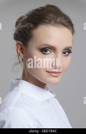 Face of beautiful young woman with blue eyes and long lashes. Beauty portrait, fresh skin. Natural makeup Stock Photo