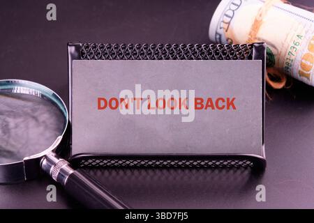 DO NOT LOOK BACK words close-up on a gray business card. Stock Photo