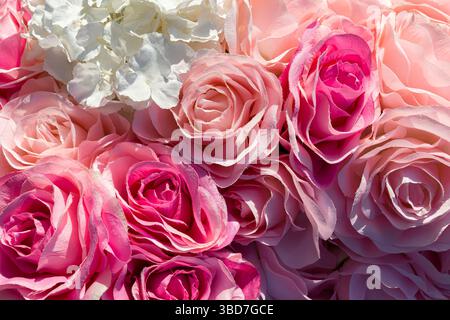 Close-up of soft pink and white artificial roses with delicate textures, ideal for romantic or decorative floral backgrounds Stock Photo
