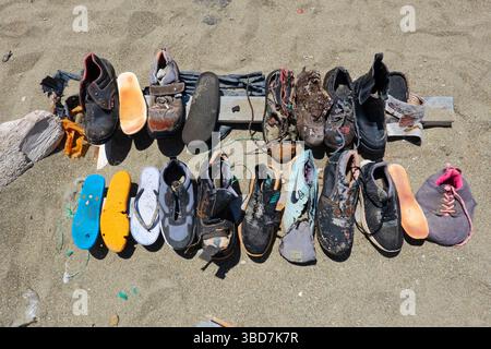 Collection of shoes, washed ashore on the beach of Crete Stock Photo