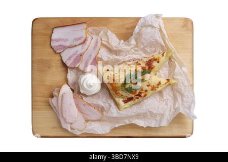 Thin pancakes stuffed with ham and bacon isolated on white Stock Photo