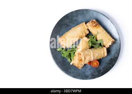 Crispy Spring Rolls on Ceramic Plate isolated on white background Stock Photo