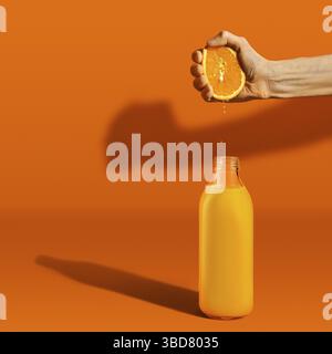 Hand squeezing orange juice in bottle on bright background. Hard light and harsh shadows Stock Photo