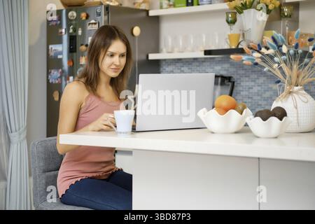 Young woman works remotely from home Stock Photo