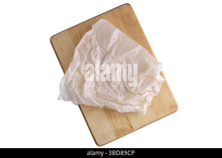 Crumpled parchment for baking isolated on white Stock Photo