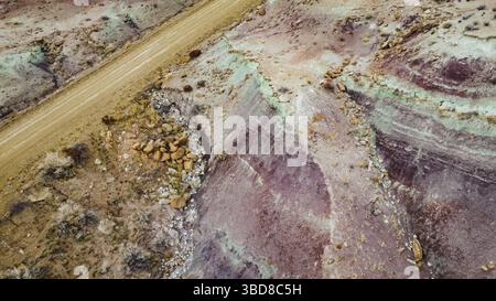 Aerial view of winding road through textured desert terrain Stock Photo