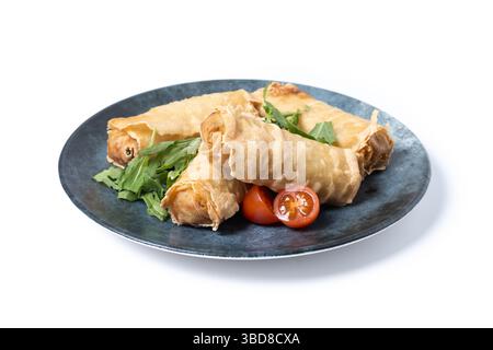 Crispy Spring Rolls on Ceramic Plate isolated on white background Stock Photo