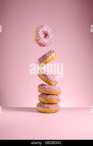 Abstract pink donuts isolated on pink background levitation Stock Photo