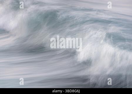 Soft ocean wave breaking on minimal ICM with blue turquoise and white Stock Photo