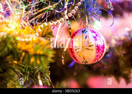 Detail of christmas decoration hangs on the tree. Christmas tree with pink, gold color and christmas ball Stock Photo