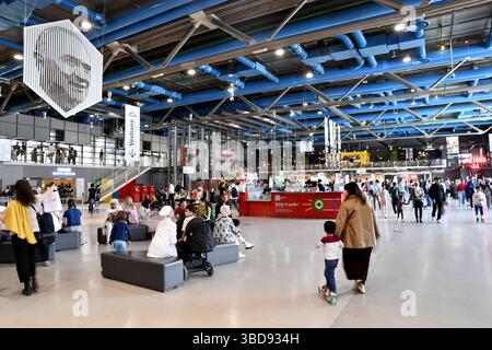 ticket area of the Centre Pompidou in Paris, featuring its signature exposed blue structural pipes on the ceiling - France Stock Photo