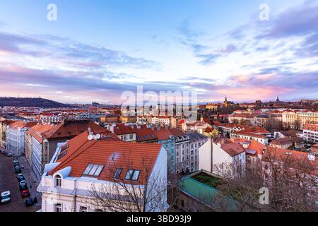 Prague panorama from Vysehrad castle. Cityscape during the sunset, magical and beautiful colors. Colorful clouds above the czech capital city. Stock Photo