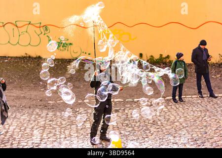 PRAGUE, CZECH REPUBLIC - 8.12.2018: Bubble artist is making soap bubbles on Prague city street. Stock Photo