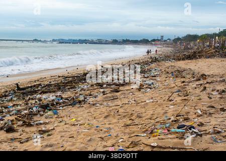 Beach covered in trash and debris. The beach is littered with plastic bottles, plastic bags, and other trash. The scene is desolate and sad, as the on Stock Photo