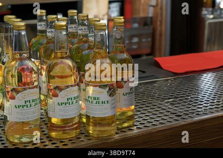 Apple juice bottles in a bar Stock Photo