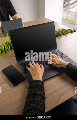 Close-up of hands typing quickly on a sleek computer keyboard, capturing the essence of productivity and digital communication in a professional setti Stock Photo